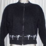 Front of Sherries Starsports Adult L, black with white figure skaters trim on lower edge
